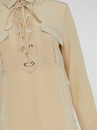 Elevate your wardrobe with the ultimate in luxury and sophistication - the Beige Lace Up Blouse by Roberto Cavalli. Crafted with exquisite attention to detail, this blouse features intricate lace detailing and a flattering silhouette that is sure to turn heads. Embrace your inner fashionista and effortlessly elevate any outfit with this chic and timeless piece.