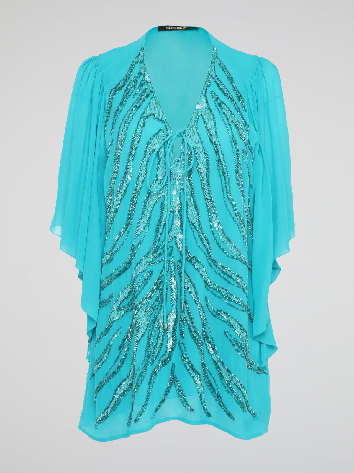 Shine like a star in the mesmerizing Blue Sequin Detailed Kaftan by Roberto Cavalli. This stunning piece features intricate sequin embellishments that capture the light and glimmer with every move you make. Perfect for a beach getaway or a special occasion, this kaftan exudes luxury and glamour, ensuring all eyes are on you wherever you go.