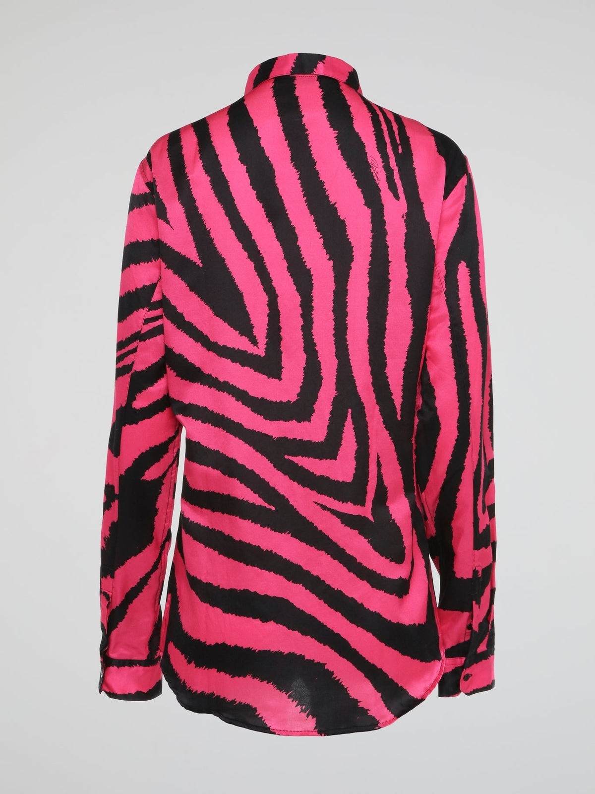 Let your wild side shine with this stunning Pink Zebra Print Shirt by Roberto Cavalli, crafted for the fashion-forward individual who dares to stand out from the crowd. Made with luxurious materials and impeccable attention to detail, this shirt is a bold statement piece that exudes confidence and style. Embrace your inner fashionista and make heads turn wherever you go with this eye-catching and trendy wardrobe essential.