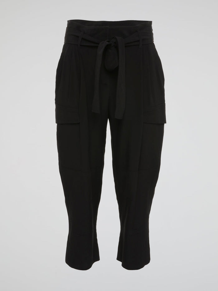 Feel fierce and fabulous in these Black Cargo Capris by Roberto Cavalli - a must-have staple for your wardrobe. The edgy cargo pockets add a unique touch to these versatile capris, perfect for any occasion. Make a statement and turn heads wherever you go with these chic and stylish capris.