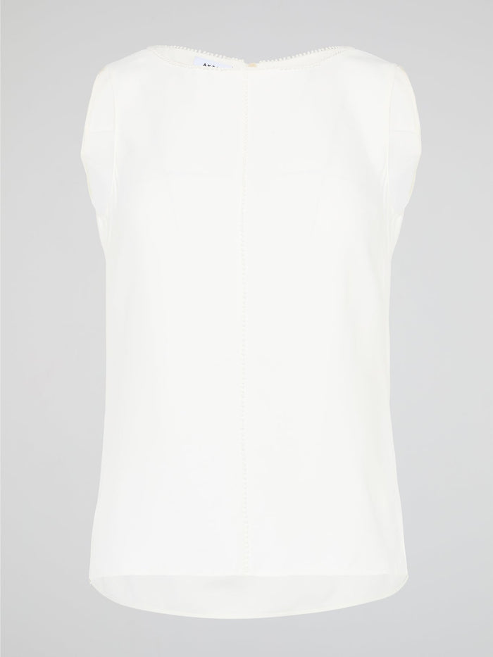 Introducing a timeless masterpiece for fashion-forward mavens - the White Sleeveless Top by Akris Punto. This ethereal beauty effortlessly combines sophistication and elegance with its minimalist design and impeccable tailoring. Crafted from luxurious fabrics, it's the perfect versatile piece to elevate your style, ensuring you're the epitome of chic from desk to dinner.