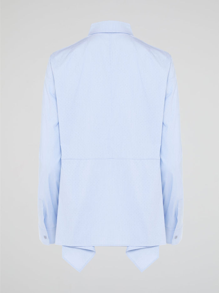 Introducing the Powder Blue High-Low Shirt by Akris Punto, where elegance meets contemporary style. Delicate powder blue hue cascades down the front, enveloping you in a calming wave of tranquility. With its unique high-low hemline and luxurious fabric, this shirt effortlessly elevates any outfit, making it a must-have piece for the fashion-forward trendsetters.