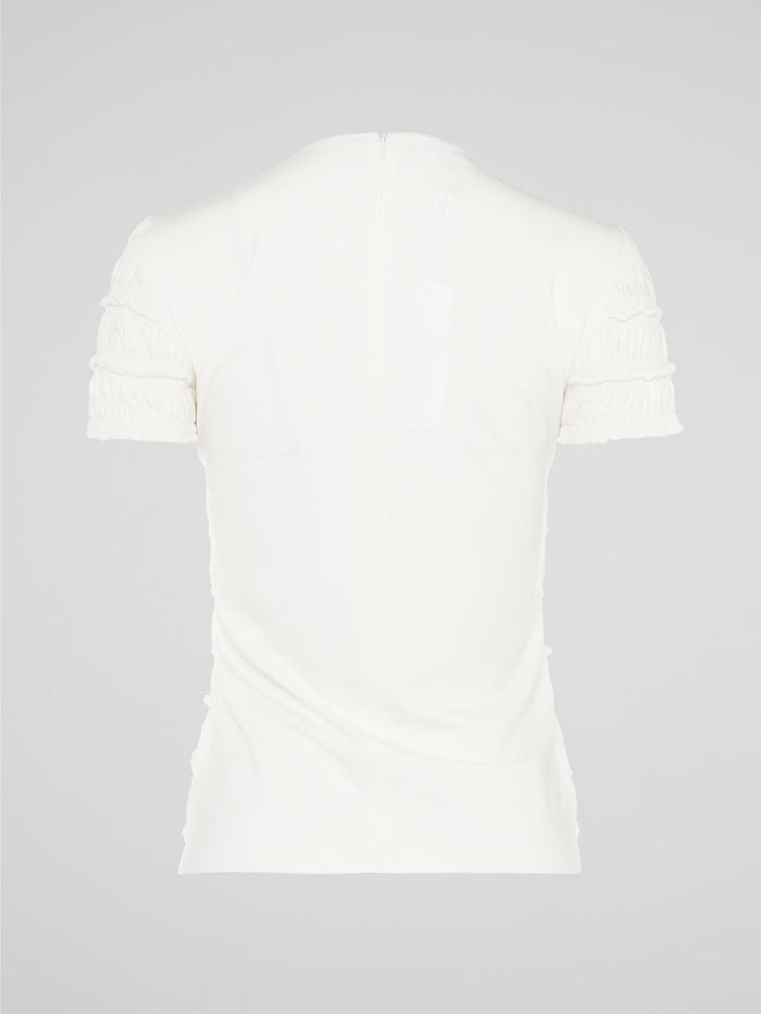 The White Tiered Top from Akris Punto is a captivating blend of sophistication and whimsy. With its unique tiered design, this versatile top adds a playful twist to any outfit. Made from premium materials, it effortlessly drapes to flatter your figure and is perfect for both casual and formal occasions.