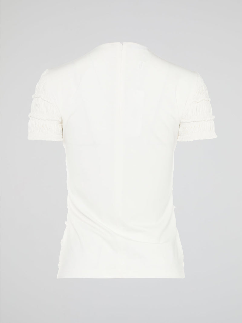 The White Tiered Top from Akris Punto is a captivating blend of sophistication and whimsy. With its unique tiered design, this versatile top adds a playful twist to any outfit. Made from premium materials, it effortlessly drapes to flatter your figure and is perfect for both casual and formal occasions.