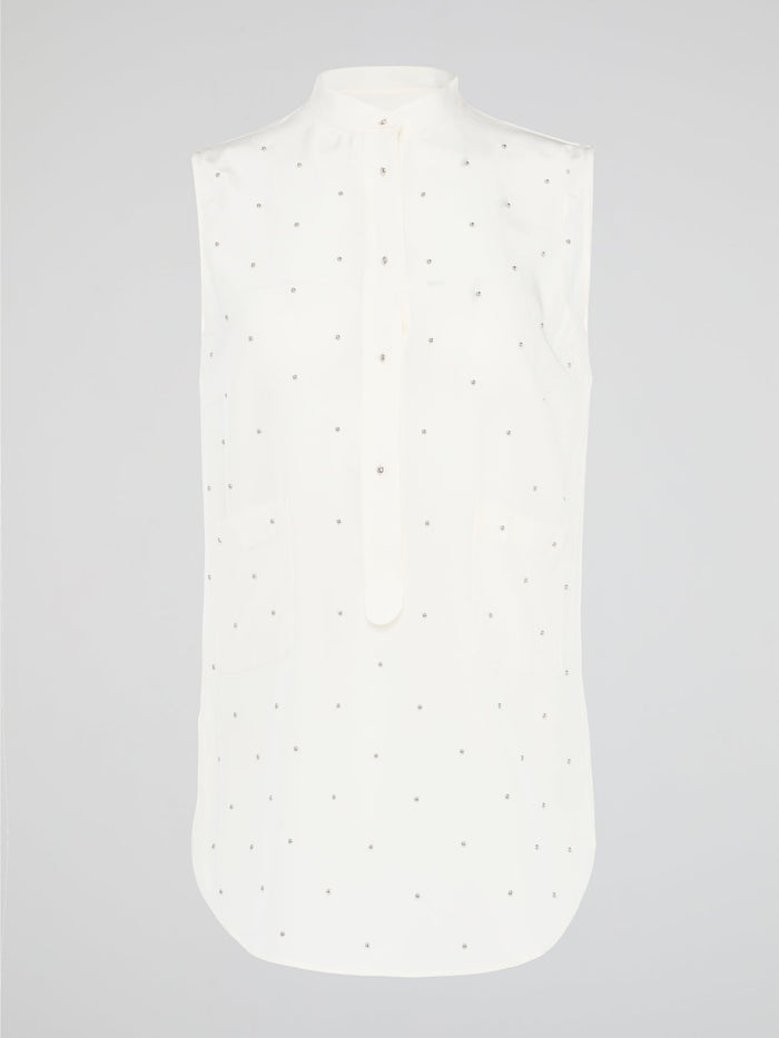 Unleash your fierce, fashion-forward side with the White Studded Sleeveless Shirt by Akris Punto. Crafted with meticulous attention to detail, this statement piece is adorned with intricately placed studs that exude edgy sophistication. Perfectly blending poise and rebellious spirit, this sleeveless shirt is a captivating must-have for those seeking to redefine their style game.