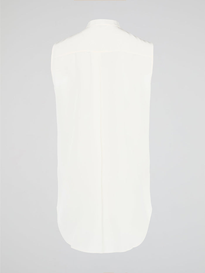 Unleash your fierce, fashion-forward side with the White Studded Sleeveless Shirt by Akris Punto. Crafted with meticulous attention to detail, this statement piece is adorned with intricately placed studs that exude edgy sophistication. Perfectly blending poise and rebellious spirit, this sleeveless shirt is a captivating must-have for those seeking to redefine their style game.