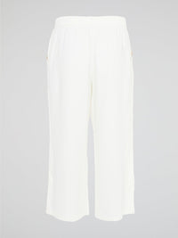 Introducing the ultimate embodiment of chic and comfort - the White Wide Leg Cropped Pants by Akris Punto. Crafted with meticulous attention to detail, these pants effortlessly blend sophistication and versatility, making them the perfect addition to any fashionista's wardrobe. Whether you're strolling on sandy beaches or attending a high-profile event, these pants will elevate your style game with their impeccable tailoring and striking silhouette.