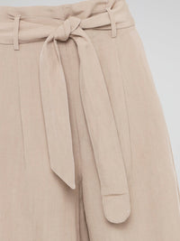 Elevate your style game with these Beige Belted Palazzo Pants from Akris Punto. Crafted with meticulous attention to detail, these pants feature a high-waisted, wide-leg silhouette that flatters every body type. The chic belted waist adds a touch of sophistication, making these pants the perfect choice for a day at the office or a stylish evening event.