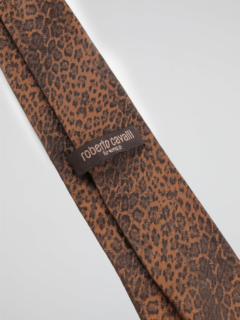 Introducing the Orange Animal Print Neck Tie by Roberto Cavalli, where fierce fashion meets untamed elegance. Crafted from luxurious silk, this eye-catching accessory features an intricate animal print in vibrant orange hues, making it a truly distinctive addition to your wardrobe. Whether you're heading to a formal event or want to add a wild touch to your everyday style, this neck tie will undoubtedly make you the king of the concrete jungle.