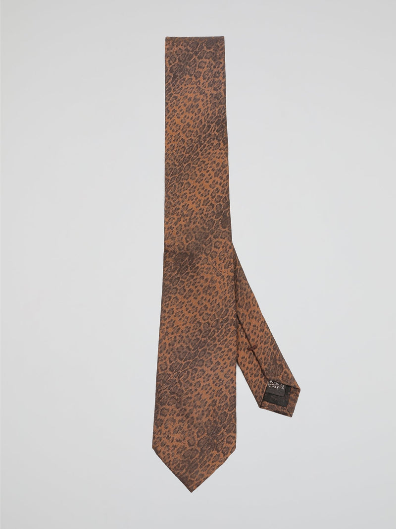 Introducing the Orange Animal Print Neck Tie by Roberto Cavalli, where fierce fashion meets untamed elegance. Crafted from luxurious silk, this eye-catching accessory features an intricate animal print in vibrant orange hues, making it a truly distinctive addition to your wardrobe. Whether you're heading to a formal event or want to add a wild touch to your everyday style, this neck tie will undoubtedly make you the king of the concrete jungle.