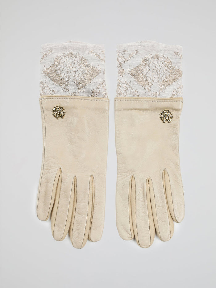 Step into luxury with these exquisite Beige Logo Embellished Gloves by Roberto Cavalli. Crafted with precision and elegance, these gloves feature the iconic Roberto Cavalli logo tastefully embellished on the fine beige leather. Whether you're strolling through the city or attending a glamorous event, these gloves will add a touch of opulence and sophistication to any outfit.