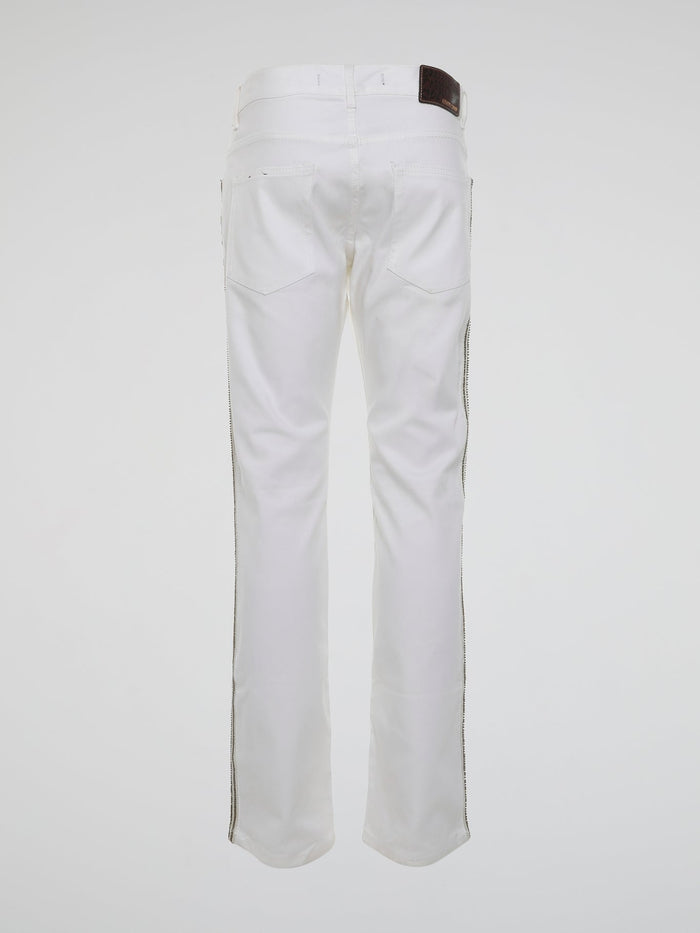 Step into the realm of high fashion with these White Studded Trousers by Roberto Cavalli. Made for those who dare to be different, these trousers feature meticulous studded details that add a touch of rebellious glamour. With their sleek design and luxurious fabric, they are the ultimate statement piece for any fashion-forward individual.