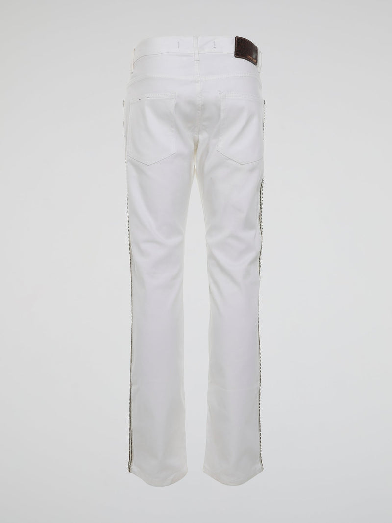 Step into the realm of high fashion with these White Studded Trousers by Roberto Cavalli. Made for those who dare to be different, these trousers feature meticulous studded details that add a touch of rebellious glamour. With their sleek design and luxurious fabric, they are the ultimate statement piece for any fashion-forward individual.