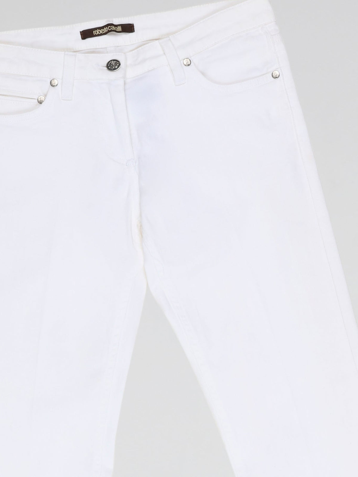 Step into fashion-forward elegance with these White Flared Jeans from renowned designer Roberto Cavalli. Crafted with meticulous attention to detail, these jeans feature a flattering high waistline and a mesmerizing flared silhouette that effortlessly elongates your legs. The pure white hue adds a touch of sophistication, making them the perfect statement piece for any occasion.