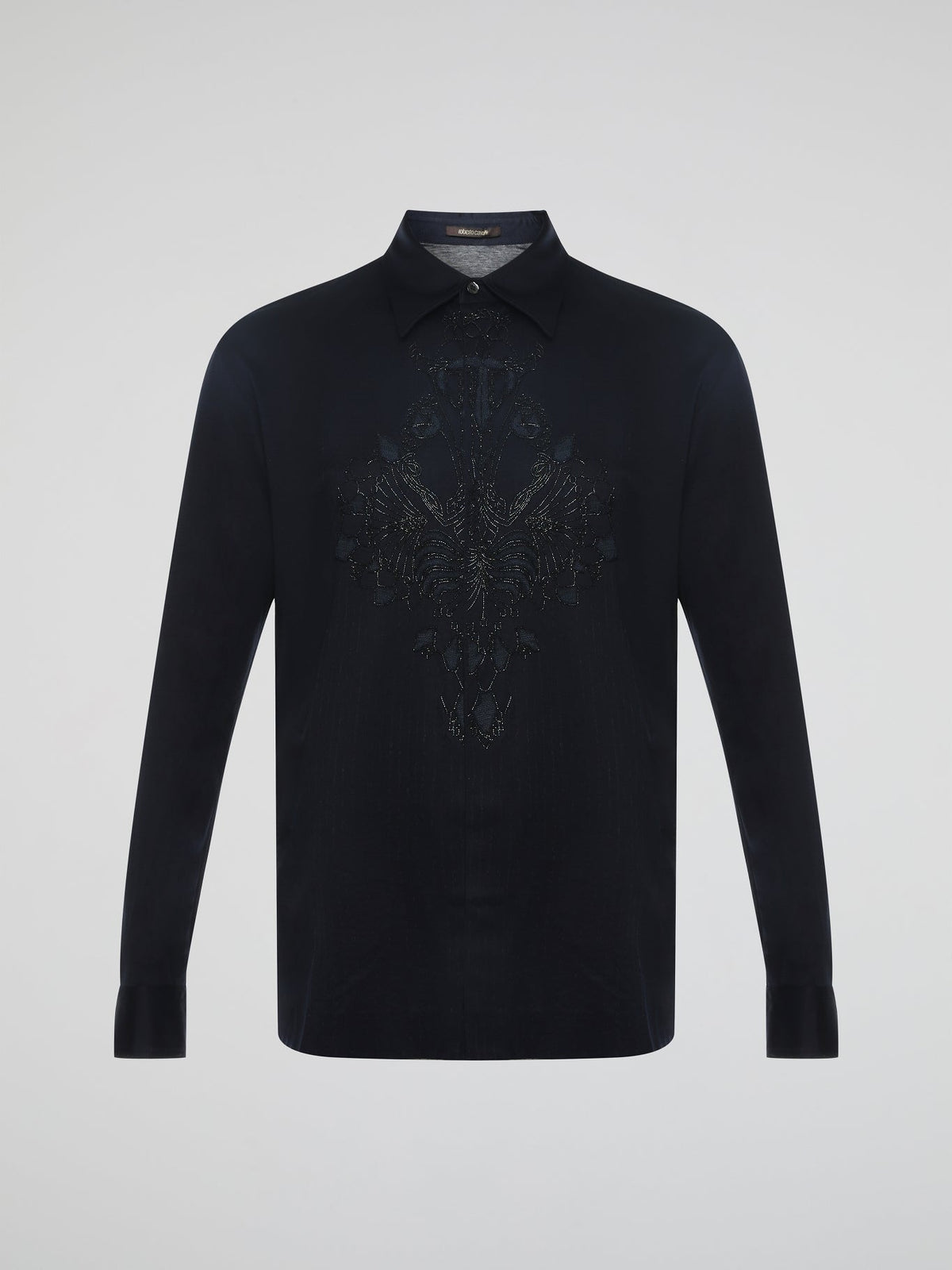 Step into the realm of effortless elegance with the captivating Black Embroidered Shirt by Roberto Cavalli. Adorned with intricate embroidery and delicate lace details, this shirt is a mesmerizing fusion of sophistication and sensuality. Elevate your style with this statement piece that exudes an air of mystique and timeless allure.