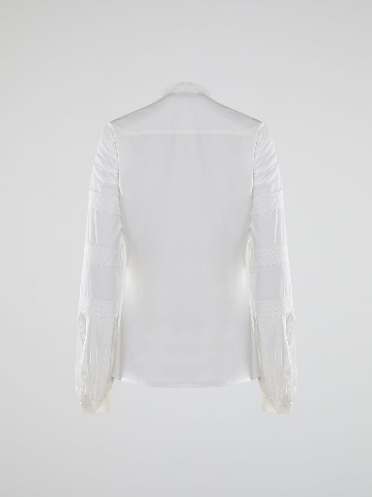 Step into the world of timeless elegance with the White Pleated Bib Shirt from Roberto Cavalli. Crafted with meticulous attention to detail, this masterpiece combines effortless sophistication with a touch of whimsical charm. From its delicate pleated bib to its crisp white fabric, this shirt will make a statement in any setting, exuding refined elegance that is truly captivating.