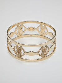 Introducing the luxurious Gold Logo Bangle by the esteemed Roberto Cavalli ��� a true masterpiece for the fashion connoisseurs. Crafted with utmost precision, this exquisite accessory showcases an iconic logo motif beautifully engraved in gold, reflecting elegance and sophistication. Elevate your style and make a bold statement with this dazzling bangle, commanding attention from every angle.