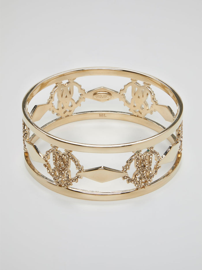 Introducing the luxurious Gold Logo Bangle by the esteemed Roberto Cavalli ��� a true masterpiece for the fashion connoisseurs. Crafted with utmost precision, this exquisite accessory showcases an iconic logo motif beautifully engraved in gold, reflecting elegance and sophistication. Elevate your style and make a bold statement with this dazzling bangle, commanding attention from every angle.