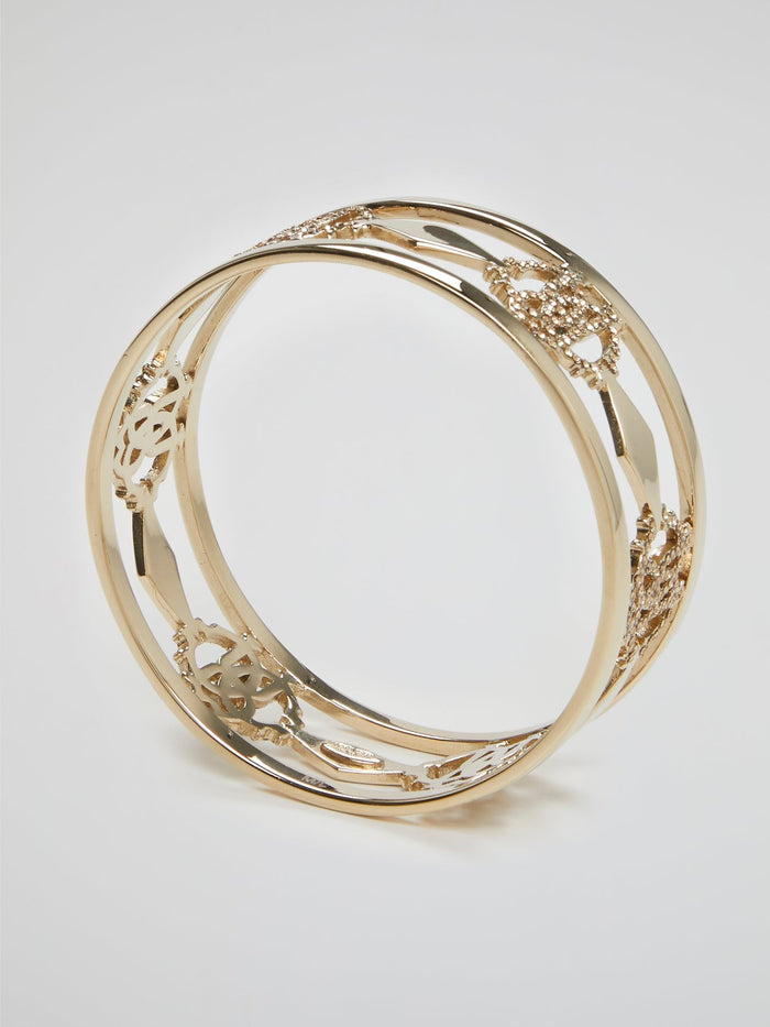 Introducing the luxurious Gold Logo Bangle by the esteemed Roberto Cavalli ��� a true masterpiece for the fashion connoisseurs. Crafted with utmost precision, this exquisite accessory showcases an iconic logo motif beautifully engraved in gold, reflecting elegance and sophistication. Elevate your style and make a bold statement with this dazzling bangle, commanding attention from every angle.
