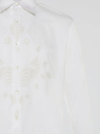 Step into a realm of elegance with the White Embroidered Shirt by Roberto Cavalli, where classic sophistication meets modern charm. Crafted with meticulous attention to detail, this shirt showcases exquisite floral embroidery that dances gracefully across the pristine white fabric. Embrace your inner fashion icon as you effortlessly blend timeless style with a touch of Italian flair, making a statement that is as timeless as it is enchanting.