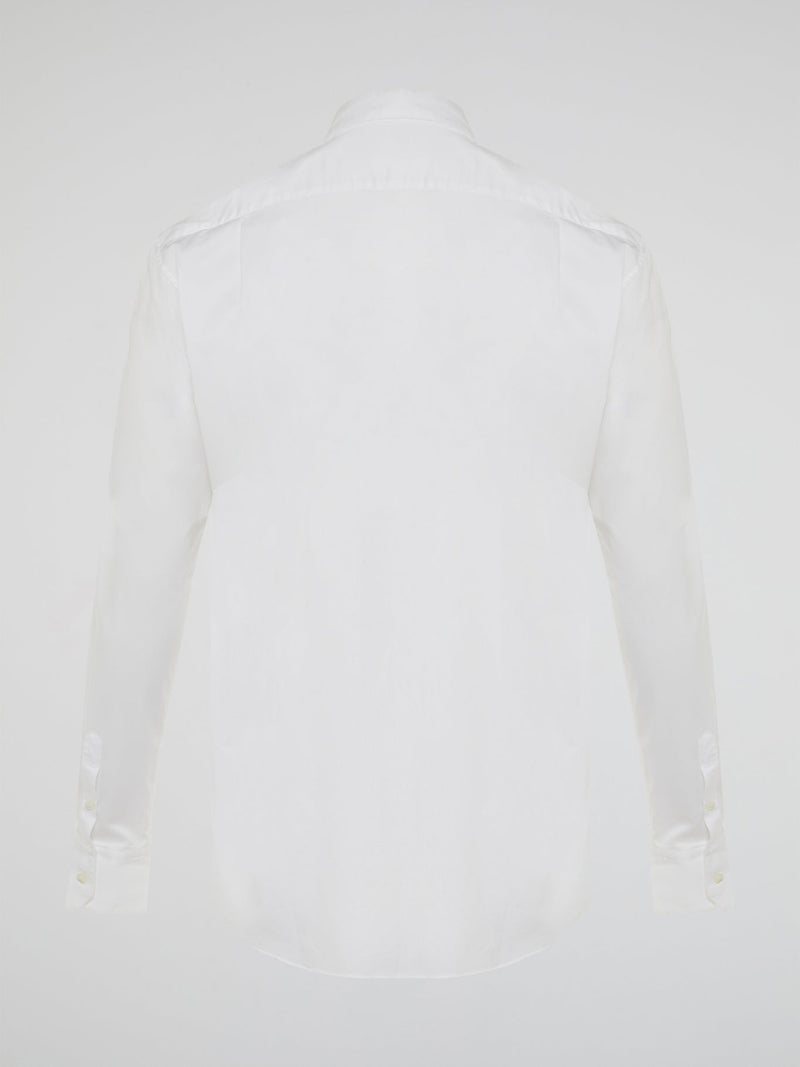 Step into a realm of elegance with the White Embroidered Shirt by Roberto Cavalli, where classic sophistication meets modern charm. Crafted with meticulous attention to detail, this shirt showcases exquisite floral embroidery that dances gracefully across the pristine white fabric. Embrace your inner fashion icon as you effortlessly blend timeless style with a touch of Italian flair, making a statement that is as timeless as it is enchanting.