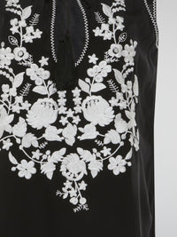 Step into a world of romantic charm with our mesmerizing Black Floral Embroidered Top by Parosh. Delicate blooms in rich hues beautifully cascade over the sheer fabric, creating a captivating visual play. This ethereal piece effortlessly blends sophistication with a hint of bohemian allure, making it a must-have for any fashion enthusiast.