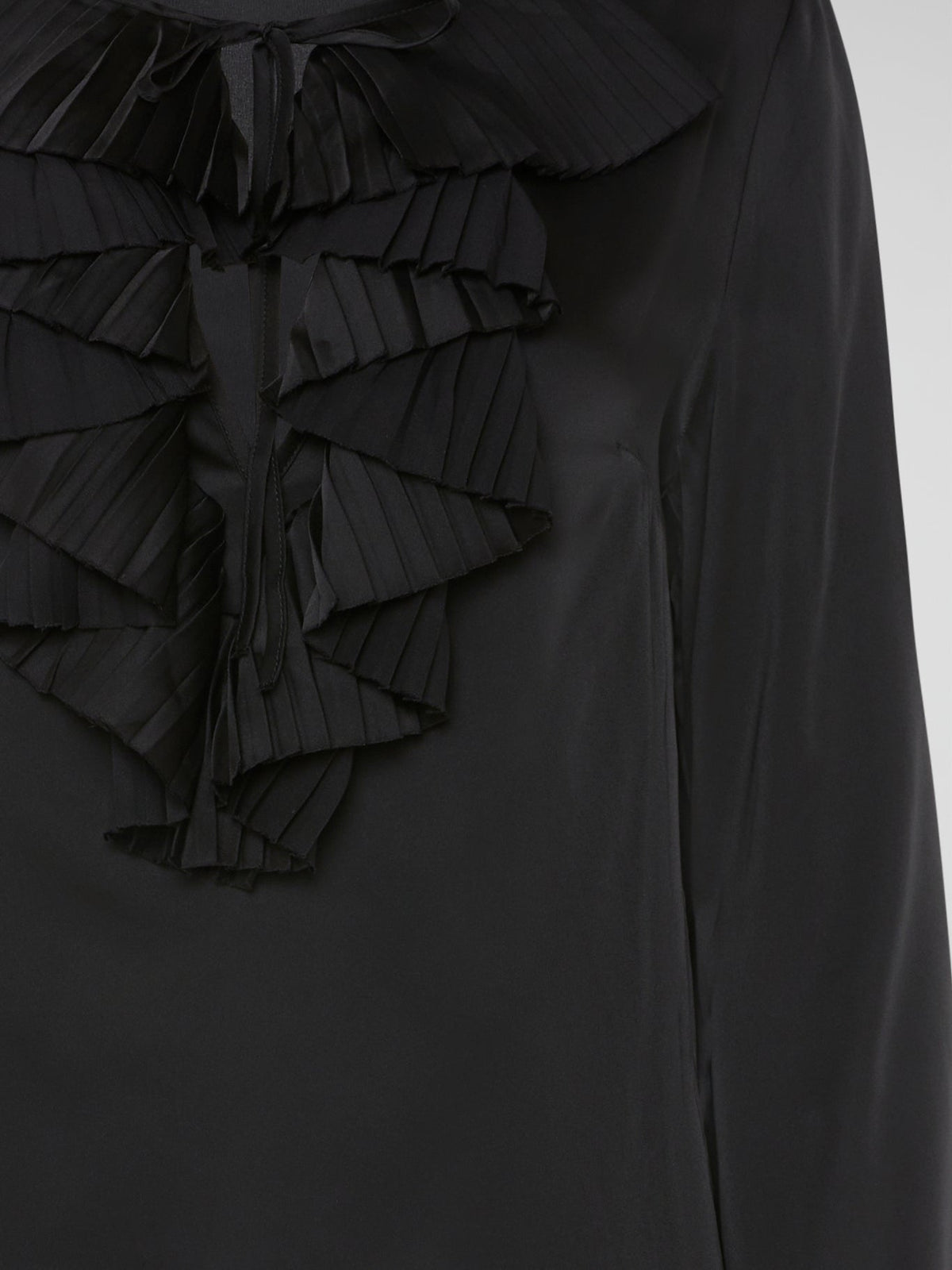 Introducing the Black Ruffle Bib Blouse by Parosh, where timeless elegance meets playful charm. Crafted with utmost precision, this statement piece features a beautifully sculpted ruffle bib that adds a touch of whimsy to your ensemble. With its sophisticated black hue and impeccable tailoring, this blouse is a must-have addition to your wardrobe, seamlessly elevating any outfit from day to night.