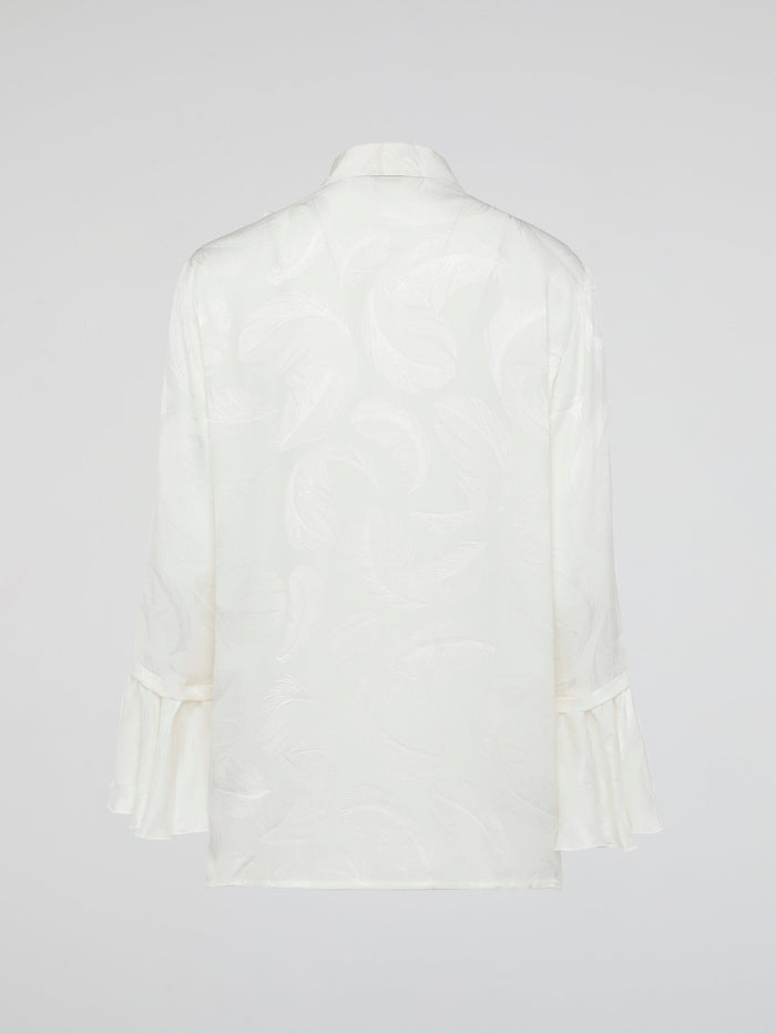 Embrace the essence of high-end fashion with the Ruffle Detailed Shirt by Roberto Cavalli. This stunning piece perfectly combines elegance and playfulness with its intricate ruffles that gracefully dance along the collar and cuffs. Crafted from luxurious materials, this shirt is a true statement piece that effortlessly elevates any outfit.