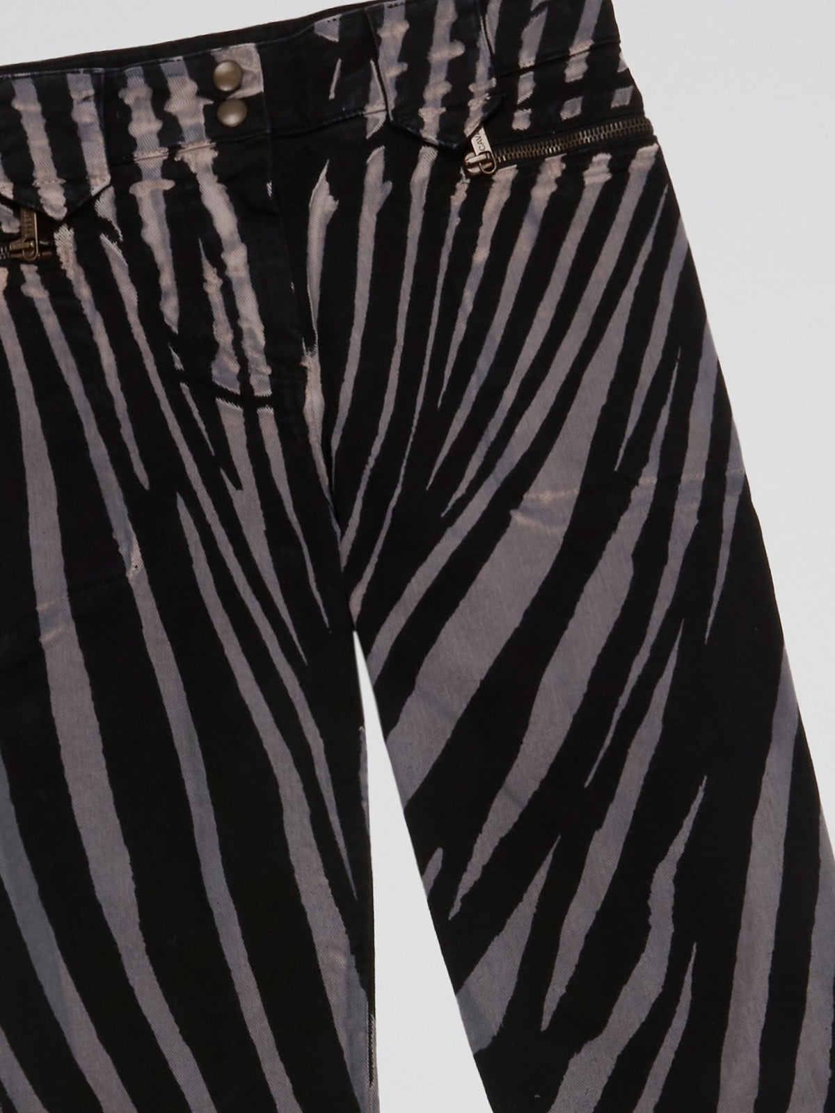 Step into the wild side with these Zebra Print Trousers by Roberto Cavalli and let your fashion roar! Crafted from luxurious fabric, these trendy trousers feature the iconic zebra print, adding a touch of untamed elegance to your wardrobe. Whether paired with a bold blazer or a simple blouse, these trousers are bound to make a fierce fashion statement wherever you go.