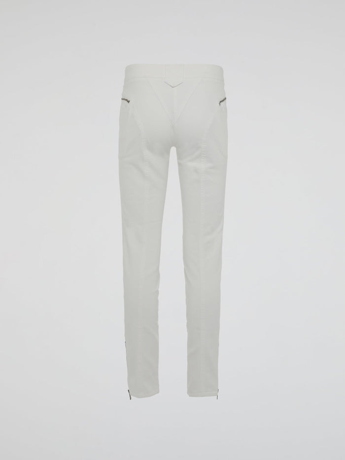 Introducing the epitome of style and sophistication - the White Zipper Detailed Trousers by Roberto Cavalli. These exquisite trousers blend modern minimalism with edgy details, boasting a sleek white hue that exudes elegance. The alluring zipper accents strategically placed throughout add a touch of rebellious charm, making these trousers a true fashion statement.