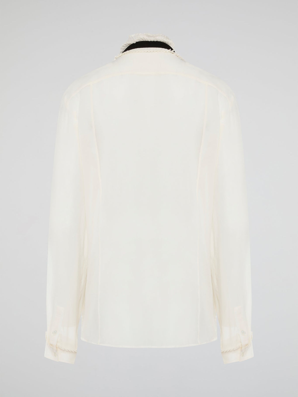 Step into luxury and sophistication with the Roberto Cavalli White Frill Detailed Blouse. The delicate frill detailing adds a touch of elegance to this classic white blouse, making it a perfect choice for any special occasion. Elevate your wardrobe with this timeless piece that exudes high-end fashion and style.