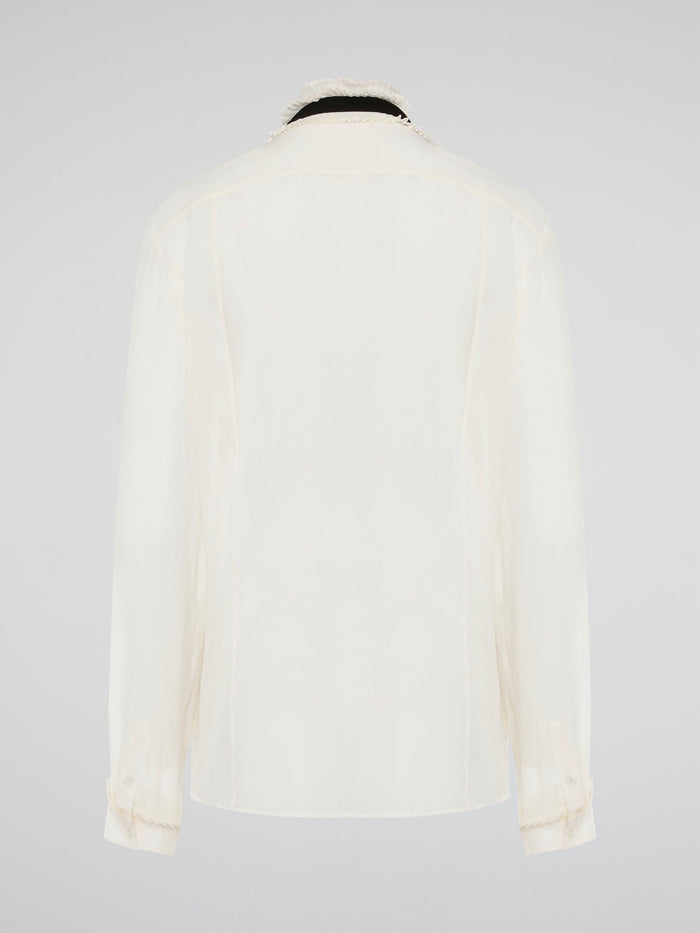 Step into luxury and sophistication with the Roberto Cavalli White Frill Detailed Blouse. The delicate frill detailing adds a touch of elegance to this classic white blouse, making it a perfect choice for any special occasion. Elevate your wardrobe with this timeless piece that exudes high-end fashion and style.