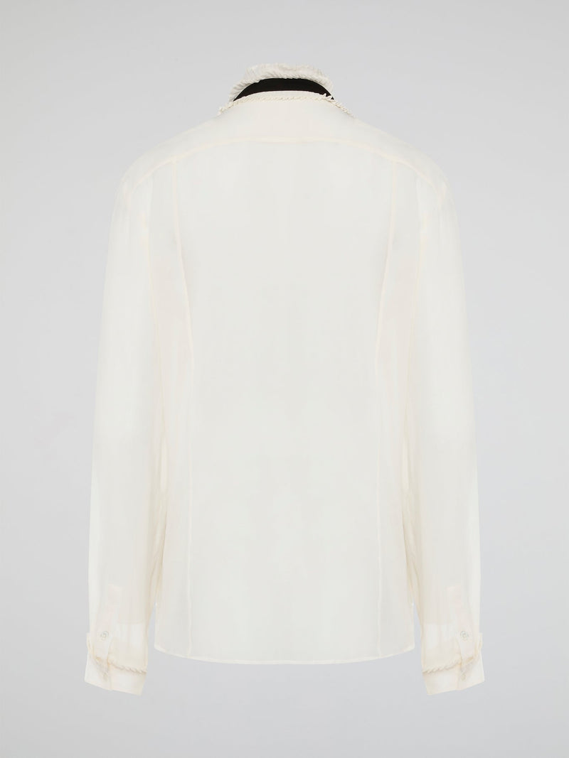 Step into luxury and sophistication with the Roberto Cavalli White Frill Detailed Blouse. The delicate frill detailing adds a touch of elegance to this classic white blouse, making it a perfect choice for any special occasion. Elevate your wardrobe with this timeless piece that exudes high-end fashion and style.