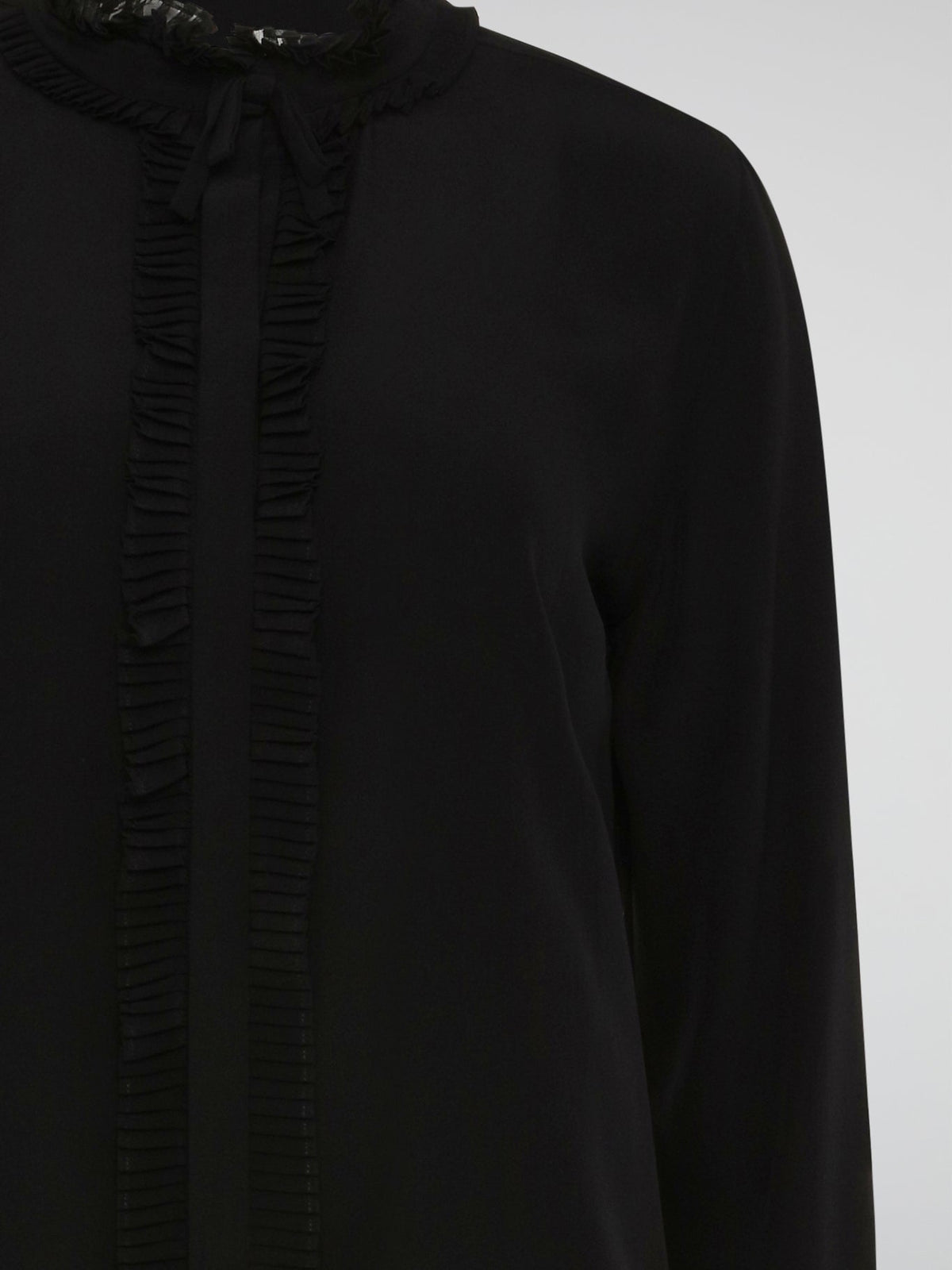 Step into the world of high fashion with this Roberto Cavalli Black Frill Detailed Blouse. The flowing silhouette is accentuated by intricate frill detailing, adding a touch of drama and elegance to any outfit. Whether paired with jeans for a casual chic look or with a skirt for a night out, this blouse is sure to turn heads wherever you go.