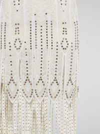 Step out in style in this stunning White Embroidered Fringe Dress from iconic designer Roberto Cavalli. The intricate embroidery detailing and playful fringe trim add a touch of bohemian elegance to this timeless piece. Whether you're hitting the beach or attending a summer soir��e, this dress is sure to turn heads and make a statement.