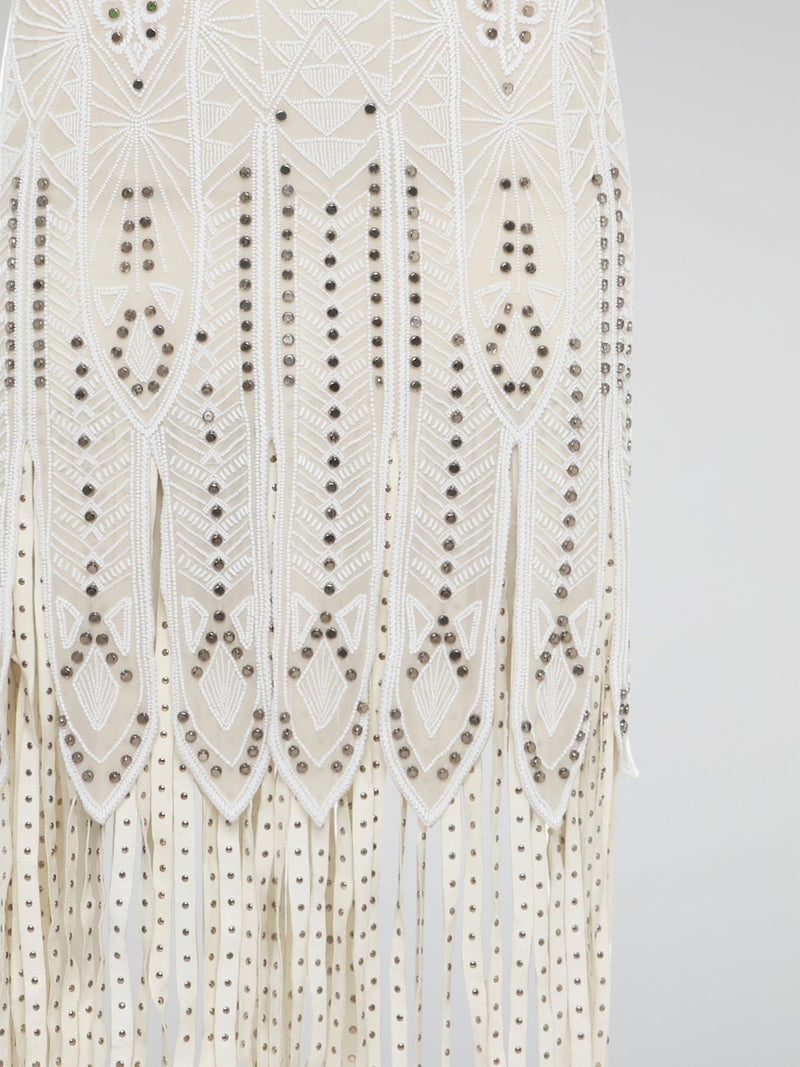 Step out in style in this stunning White Embroidered Fringe Dress from iconic designer Roberto Cavalli. The intricate embroidery detailing and playful fringe trim add a touch of bohemian elegance to this timeless piece. Whether you're hitting the beach or attending a summer soir��e, this dress is sure to turn heads and make a statement.