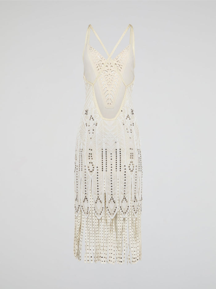 Step out in style in this stunning White Embroidered Fringe Dress from iconic designer Roberto Cavalli. The intricate embroidery detailing and playful fringe trim add a touch of bohemian elegance to this timeless piece. Whether you're hitting the beach or attending a summer soir��e, this dress is sure to turn heads and make a statement.