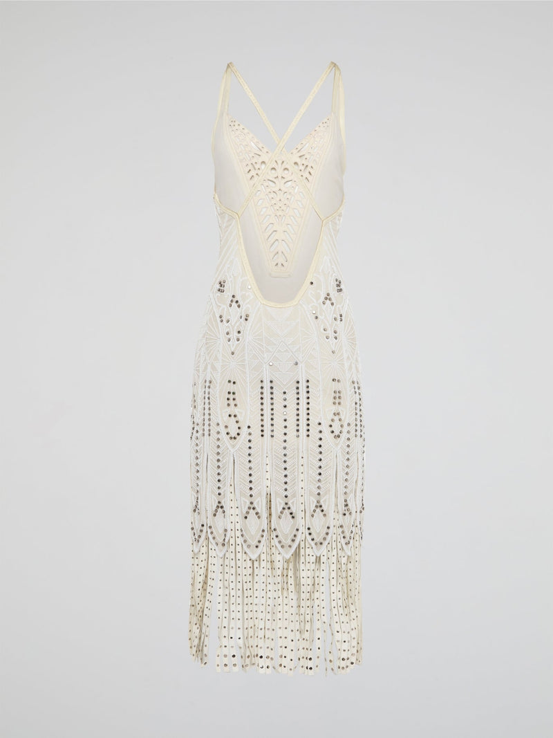 Step out in style in this stunning White Embroidered Fringe Dress from iconic designer Roberto Cavalli. The intricate embroidery detailing and playful fringe trim add a touch of bohemian elegance to this timeless piece. Whether you're hitting the beach or attending a summer soir��e, this dress is sure to turn heads and make a statement.