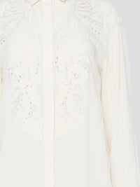 Feel like a bohemian queen in this exquisite white embroidered long sleeve blouse from Roberto Cavalli. The intricate detailing and luxurious fabric create a stunning and timeless piece that is perfect for any occasion. Elevate your wardrobe and make a statement with this elegant and unique blouse.