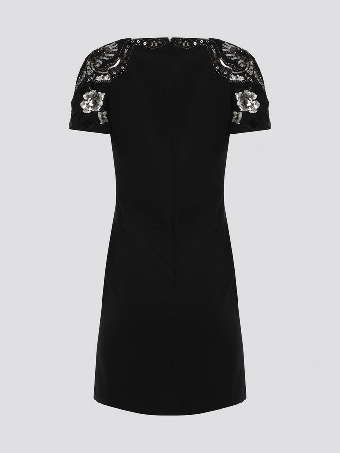 Step out in style and sophistication with our Black Embellished Plunge Dress by Roberto Cavalli. This stunning piece features intricate beadwork and shimmering embellishments that are sure to turn heads. The plunging neckline adds a touch of allure, making it the perfect choice for your next special occasion. Elevate your wardrobe with this show-stopping dress that exudes luxury and glamour.