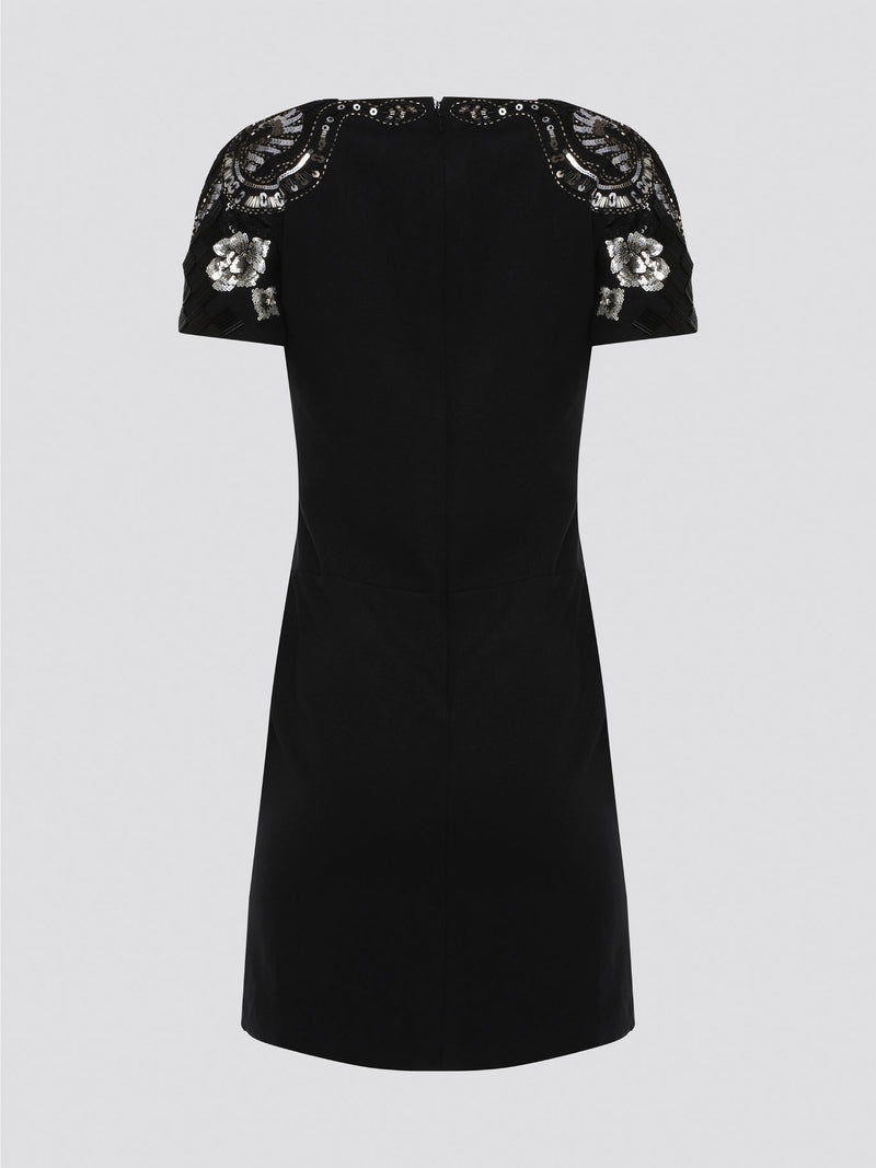 Step out in style and sophistication with our Black Embellished Plunge Dress by Roberto Cavalli. This stunning piece features intricate beadwork and shimmering embellishments that are sure to turn heads. The plunging neckline adds a touch of allure, making it the perfect choice for your next special occasion. Elevate your wardrobe with this show-stopping dress that exudes luxury and glamour.