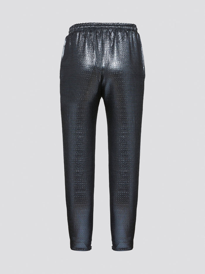 Feel your most chic and fashionable self in these stunning Blue Metallic Drawstring Pants by Markus Lupfer. The shimmering metallic finish will catch the light and turn heads wherever you go, making you the center of attention. With a comfortable drawstring waist and tapered fit, these pants are as effortless to wear as they are stylish.