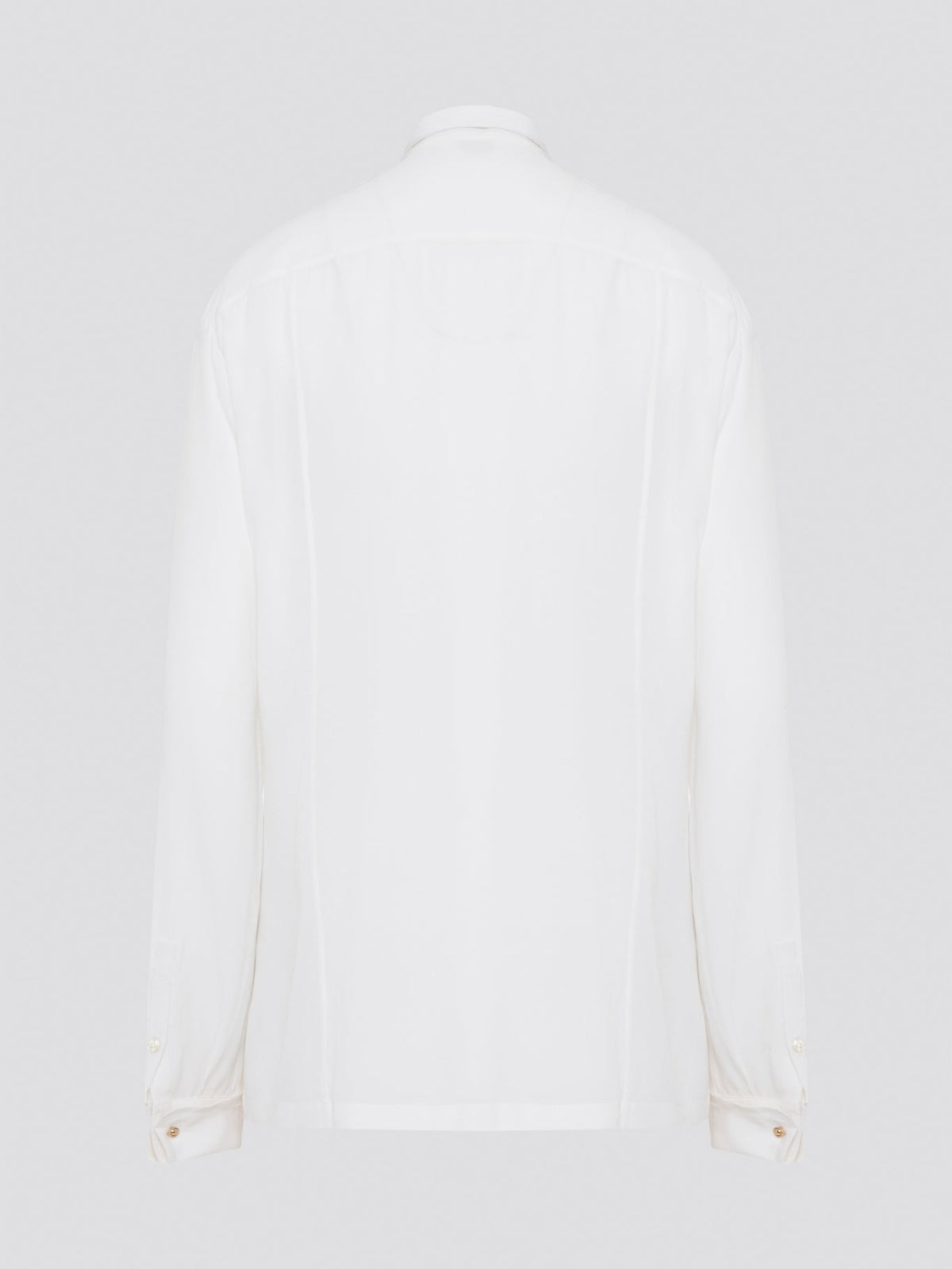 Elevate your wardrobe with this stunning Roberto Cavalli white detailed long sleeve shirt. Crafted with exquisite attention to detail, this shirt features intricate embroidery and embellishments that exude luxury and elegance. Perfect for adding a touch of sophistication to any ensemble, this statement piece is sure to turn heads wherever you go.