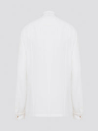 Elevate your wardrobe with this stunning Roberto Cavalli white detailed long sleeve shirt. Crafted with exquisite attention to detail, this shirt features intricate embroidery and embellishments that exude luxury and elegance. Perfect for adding a touch of sophistication to any ensemble, this statement piece is sure to turn heads wherever you go.