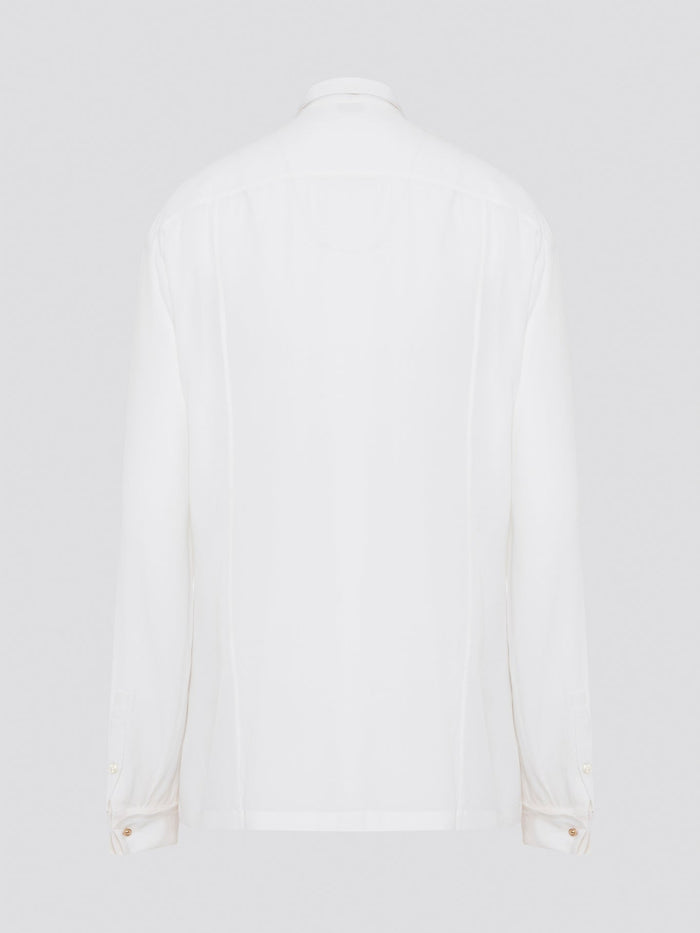 Elevate your wardrobe with this stunning Roberto Cavalli white detailed long sleeve shirt. Crafted with exquisite attention to detail, this shirt features intricate embroidery and embellishments that exude luxury and elegance. Perfect for adding a touch of sophistication to any ensemble, this statement piece is sure to turn heads wherever you go.