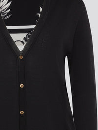 Wrap yourself in sophistication and luxury with the Black Print Panel Cardigan from Roberto Cavalli. This statement piece features a bold print design on the front panels, adding a touch of glamour to any ensemble. Whether layered over a sleek black dress or paired with jeans and a tee, this cardigan is sure to turn heads wherever you go.