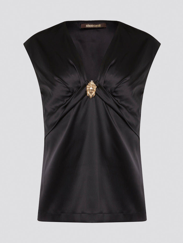 Make a bold statement with the Black Embellished Top by Roberto Cavalli, guaranteed to turn heads wherever you go. With intricate detailing and luxurious fabrics, this top is the epitome of high-end fashion. Elevate your wardrobe and stand out from the crowd with this stunning piece from one of the world's most renowned designers.