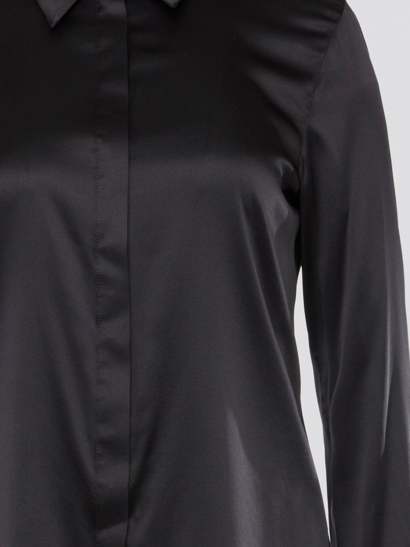 Step out in sleek and sophisticated style with this black satin shirt from Roberto Cavalli, a luxurious addition to your wardrobe. The silky smooth fabric drapes effortlessly, while the tailored fit adds a touch of elegance to any outfit. Perfect for a night out on the town or a special event, this shirt is sure to turn heads and make a statement.