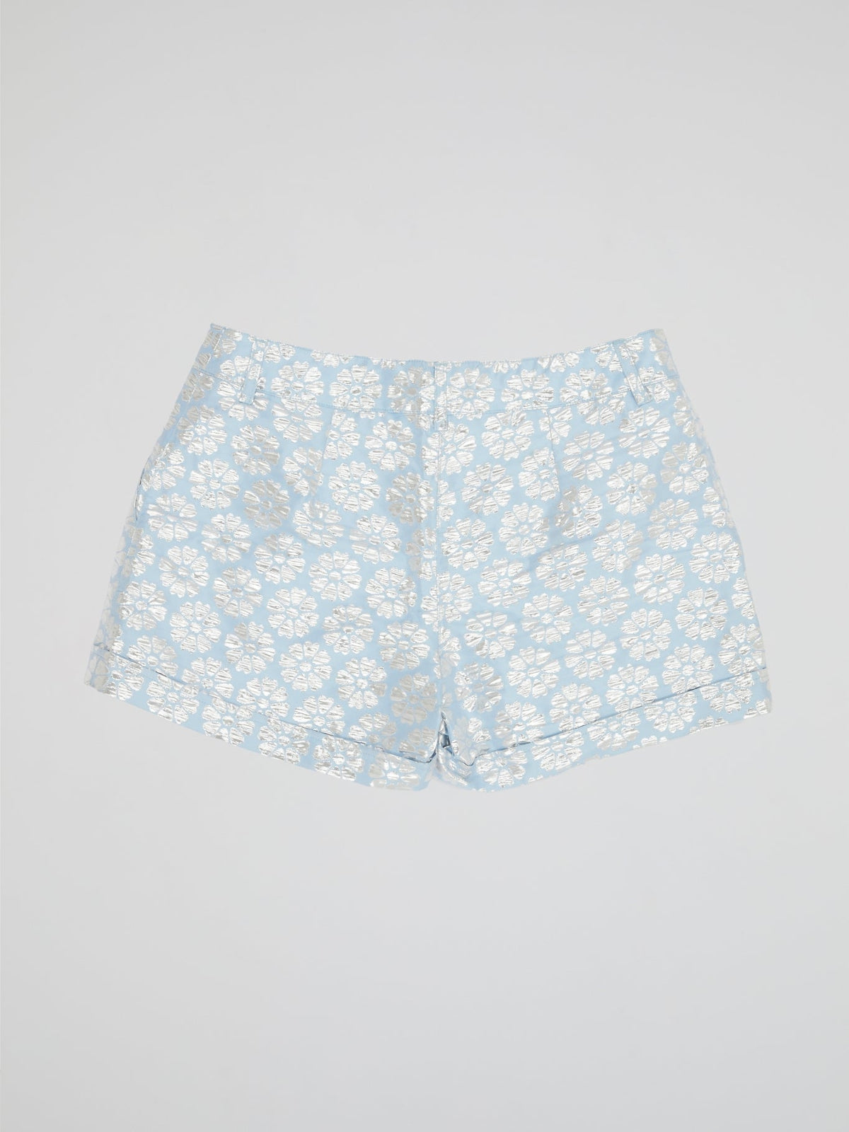 Transport yourself to a whimsical garden with these Blue Floral Print Shorts by Parosh. Made from luxurious fabric, these shorts feature a vibrant blue hue adorned with intricate floral designs for a statement-making look. Perfect for exploring the city or lounging in the sun, these shorts are a must-have addition to your wardrobe.