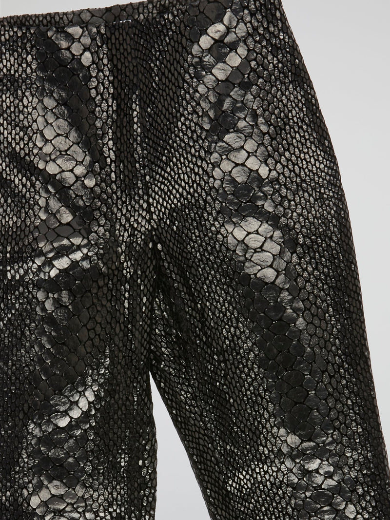 Unleash your wild side with our Black Reptilian Leather PantsIceberg, designed to make a bold statement. Crafted from high-quality faux leather with a sleek reptile texture, these pants are perfect for standing out in a crowd. Embrace your inner rockstar and take your style to the next level with these edgy and stylish pants.